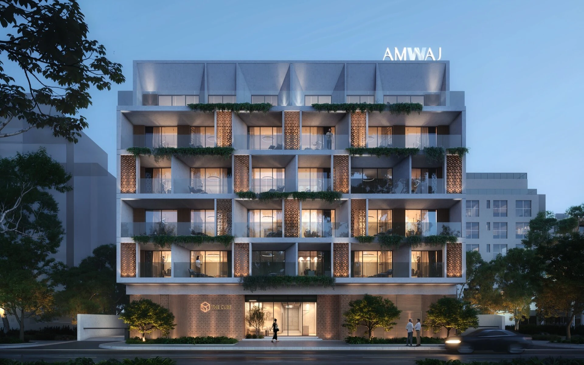 The Cube Residences illuminated facade at dusk